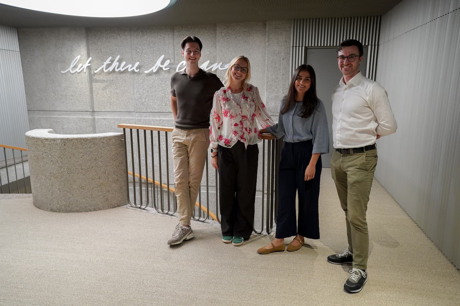 Teams pausing for a quick photo moment between meetings.