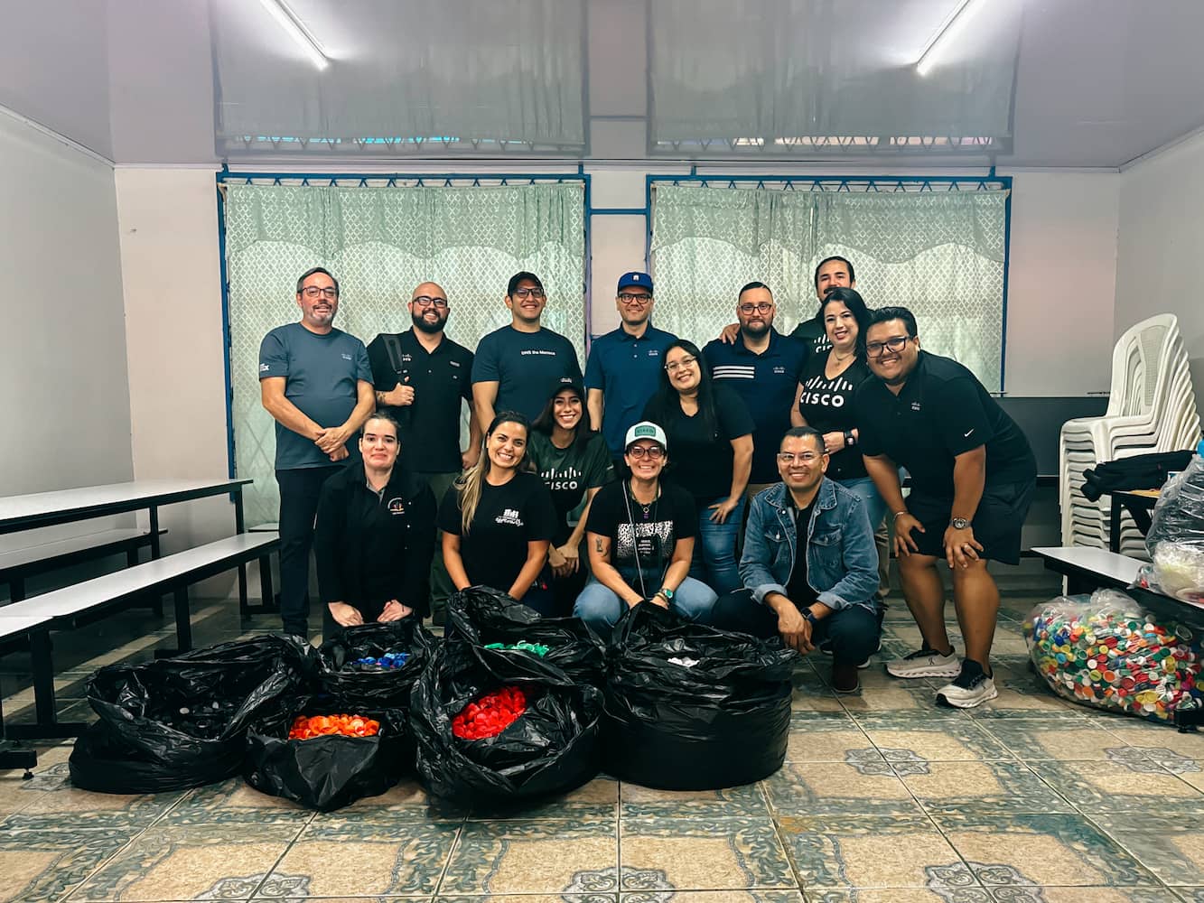 Employees in Costa Rica volunteer by sorting bottle caps to be used to create desks for students in a high-risk area. 