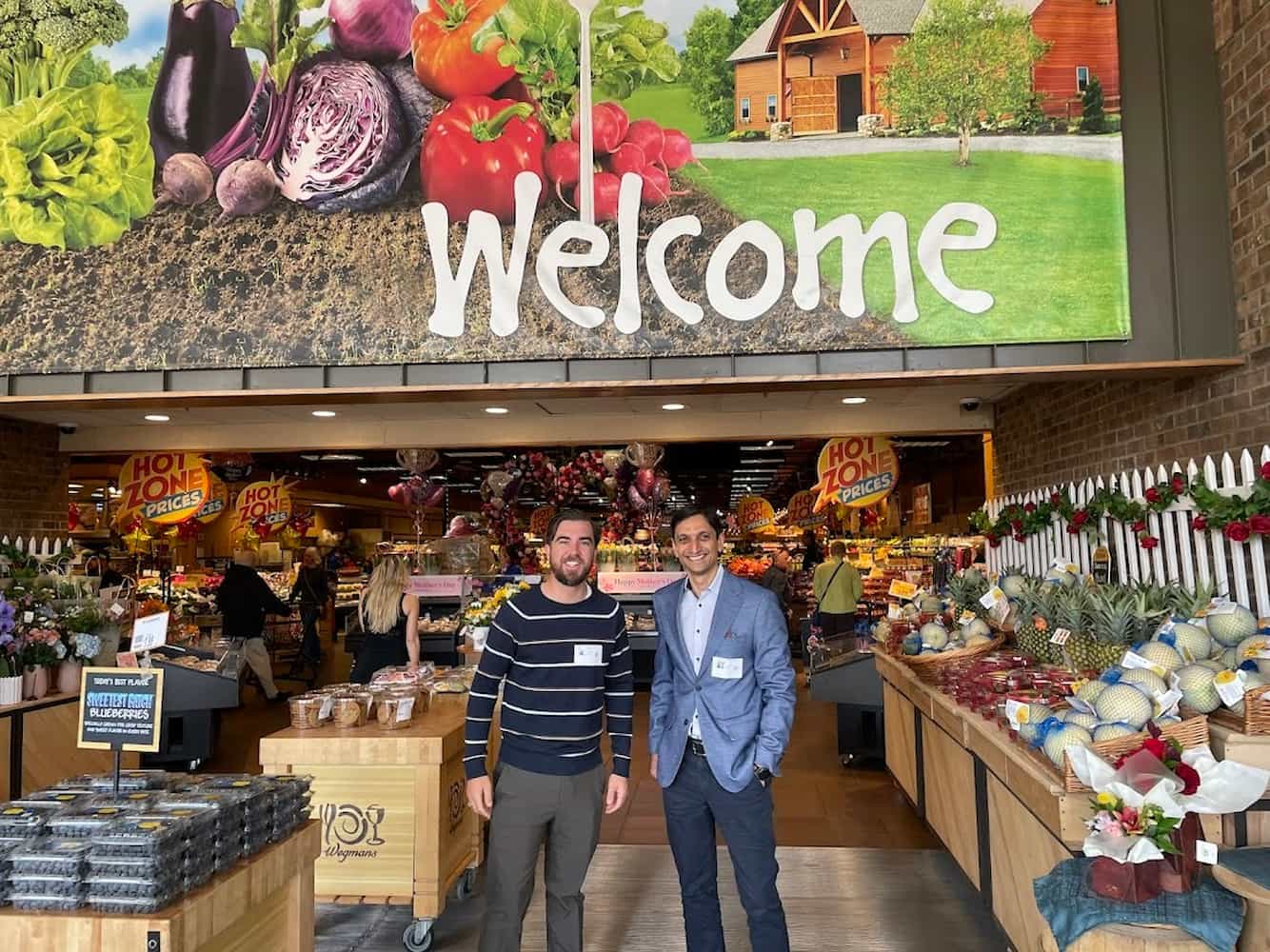 Eric and Vinay visit Wegmans onsite, surrounded by the products and people at the heart of the market.